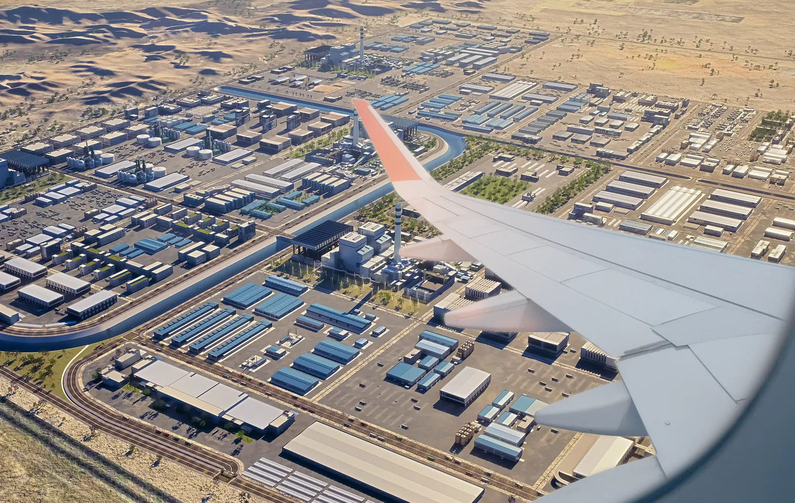 Rabigh Logistics Oases seen from the air on approach, past an aircraft wing: warehouse blocks, industrial plots and a canal laid out on a grid against the desert. Render.